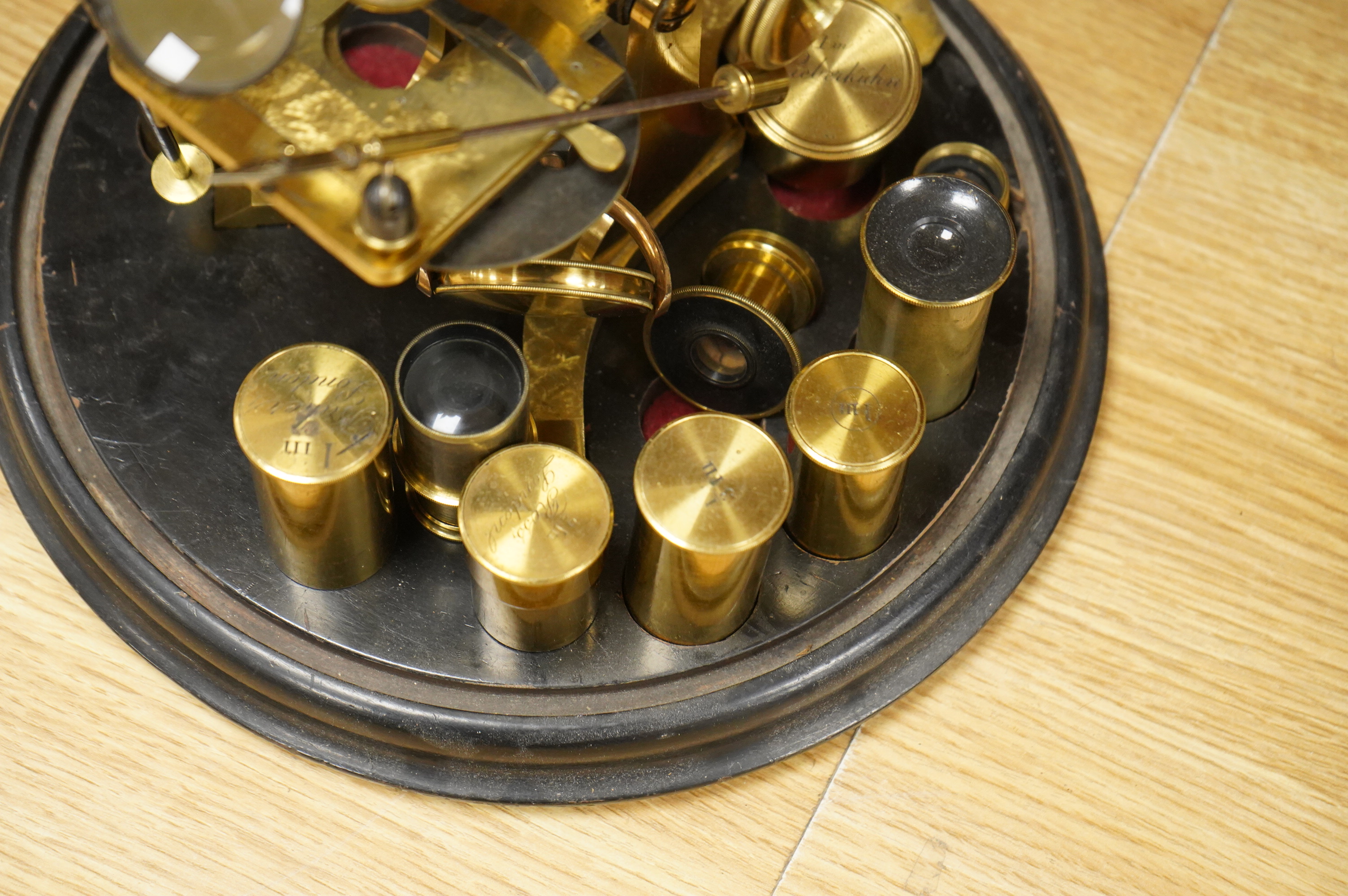 A mid 19th century brass monocular microscope, unsigned, with five objectives and three eyepieces, together with a Lieberkühn, a dark spot substage condenser, and a pair of Nicols prisms